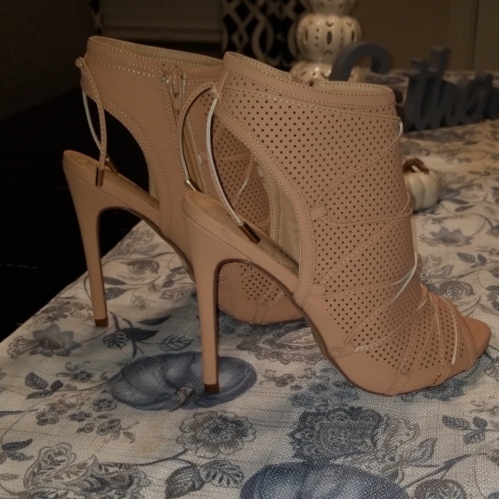 High heeled open-toe bootie. Never worn (gift).